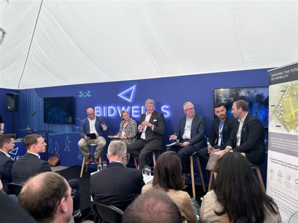 Group of people on stage delivering a talk to audience seated in foreground