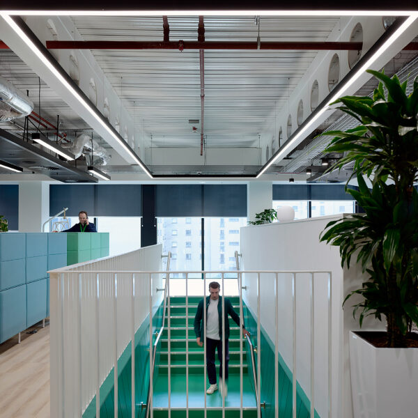 Man descending down a green staircase