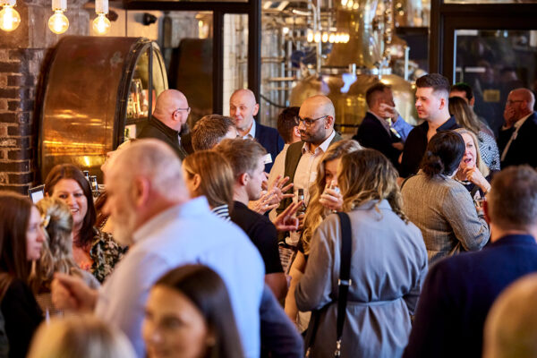 A group of men and women drinking and chatting in a bar