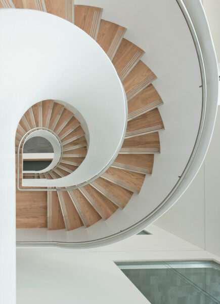 Birds eye view of the spiral staircase design reflecting onto the wooden and painted elements.