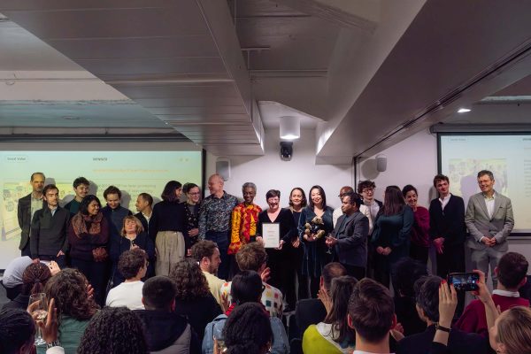 A group of people on stage to collect a public art prize