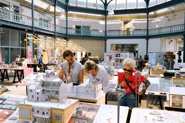 Visitors examining students' work at the Scottish Interior Design Students' Showcase.